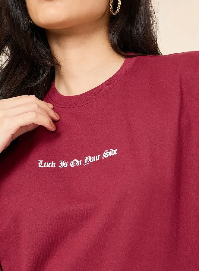 Styli Oversized Round Neck Slogan Longline T-Shirt