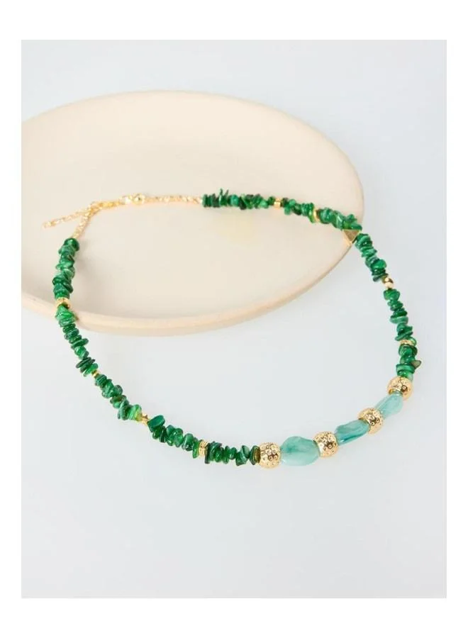 Adjustable necklace with shiny metal ball figure and green beads.