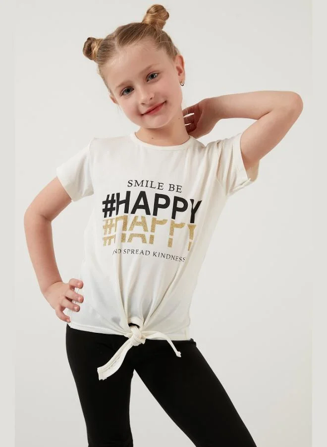 ليلا تيشيرت قطن بطبعة ليلى بتفاصيل ربطة وياقة دائرية للبنات