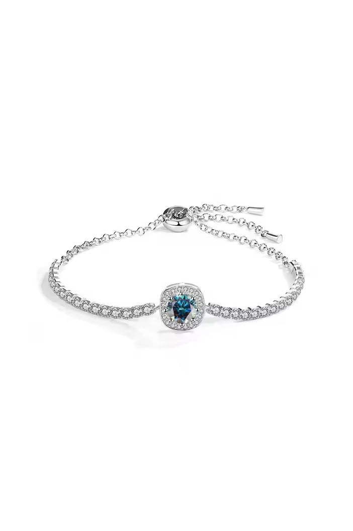 Luxuria Tennis bracelet with a blue/turquoise stone surrounded by white stones. - Image 1