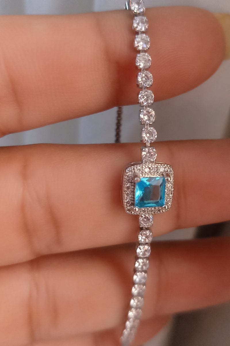 Luxuria Tennis bracelet with a blue/turquoise stone surrounded by white stones. - Image 2