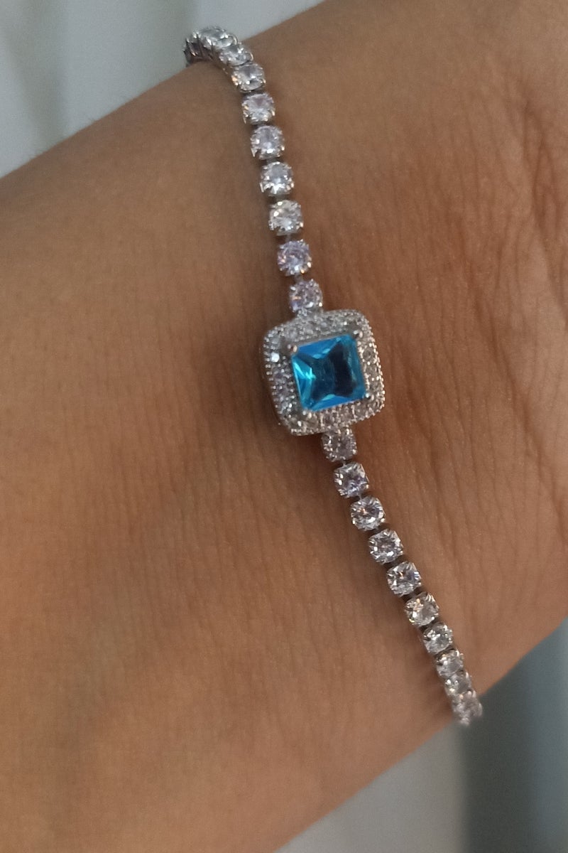 Luxuria Tennis bracelet with a blue/turquoise stone surrounded by white stones. - Image 3