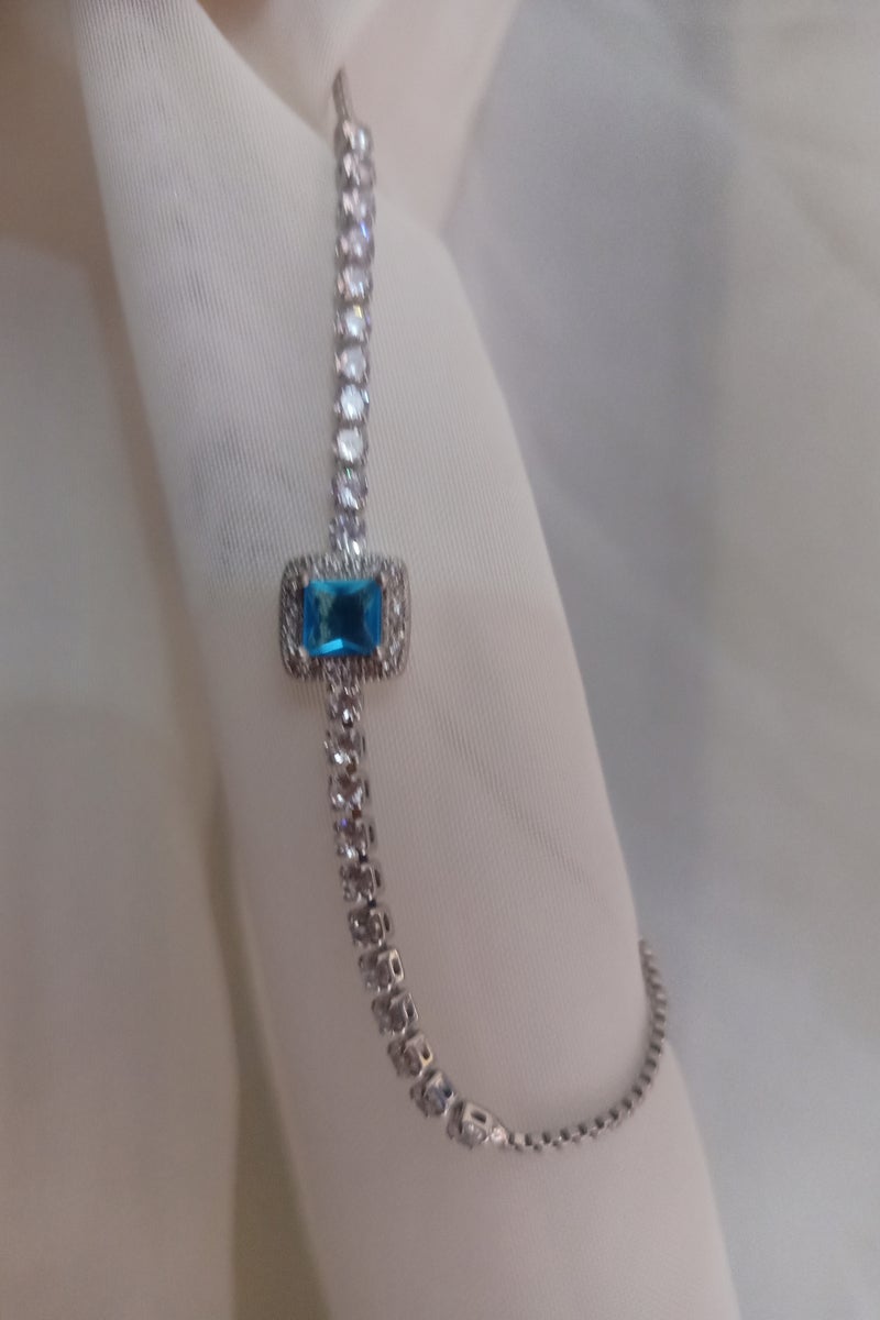 Luxuria Tennis bracelet with a blue/turquoise stone surrounded by white stones. - Image 5