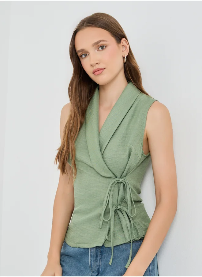 ستايلي Styli Solid Sleeveless Wrap Top with Tie-Up Detail