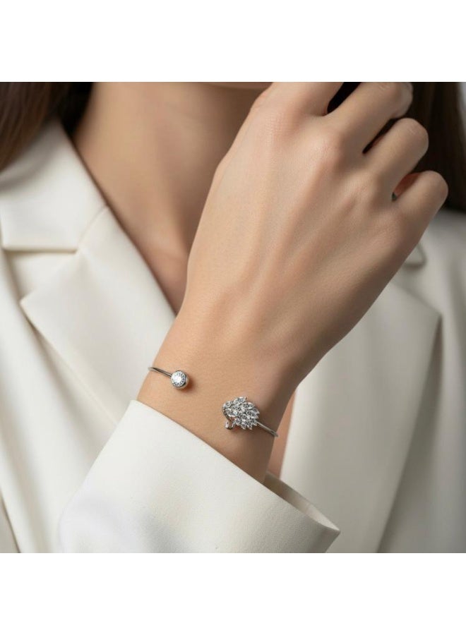 A silver-colored bracelet with an open design that combines a round zircon stone and a collection of shiny stones in the shape of a feather, a modern elegance that catches the eye. - Image 2