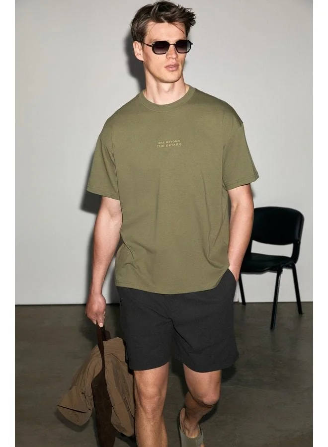 Grimelange VITO Men's 100% Organic Cotton T-Shirt with Embroidered Text Details, Oversized Loose Fit, Short Sleeve, Dark Khaki.