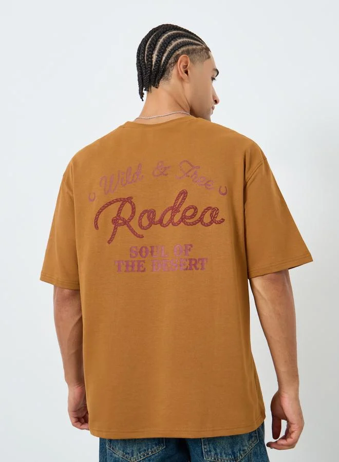 Styli  Men Brown Embroidered Slogan Oversized T-Shirt for Men | Best Price UAE