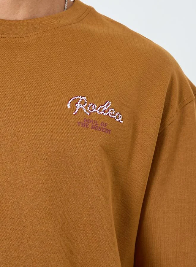 Styli  Men Brown Embroidered Slogan Oversized T-Shirt for Men | Best Price UAE