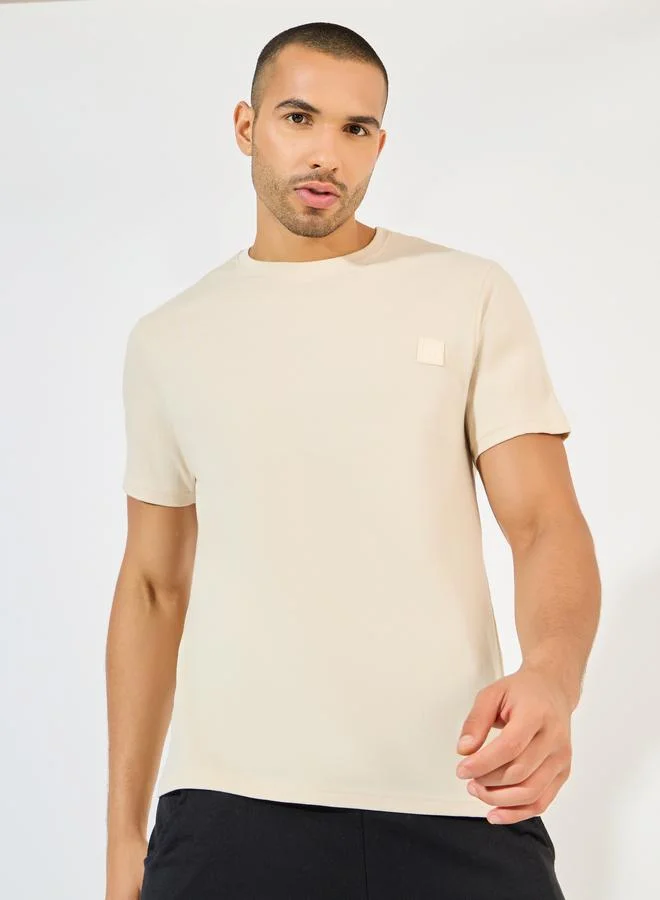 Styli Styli Crew Neck Regular Fit T-Shirt with Silicon Badge