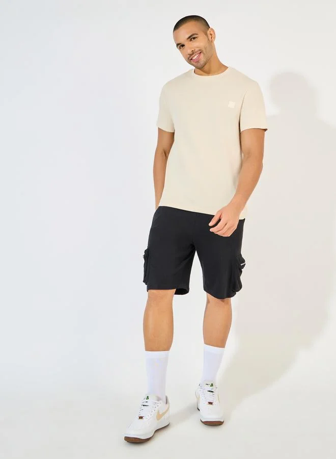 Styli Styli Crew Neck Regular Fit T-Shirt with Silicon Badge