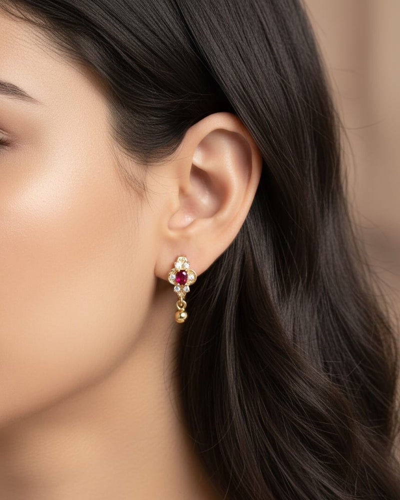 A delicate gold-plated hoop featuring a crimson red centerpiece, surrounded by the sparkle of dazzling white zircon stones. The allure is completed with a small spherical pendant. - Image 2