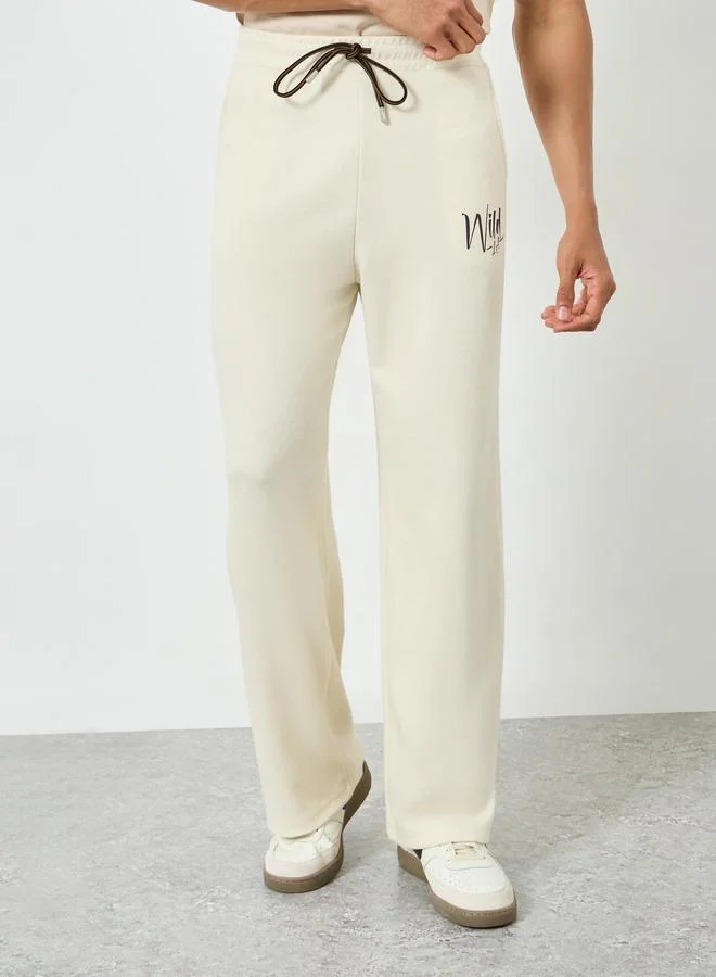 Men Cream Text Print Oversized Joggers