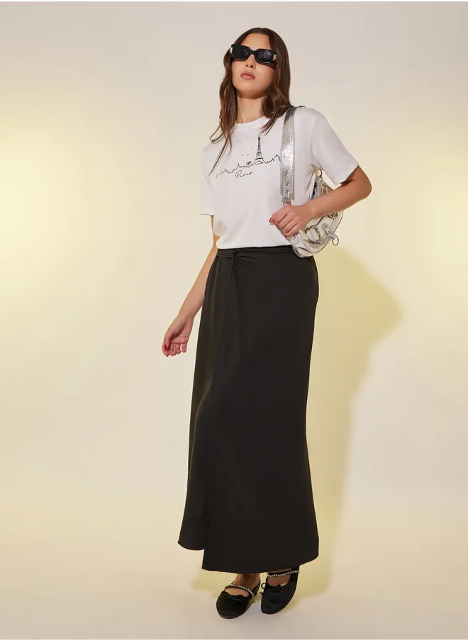 ستايلي Solid Asymmetric Hem Maxi Skirt with Twist Detail