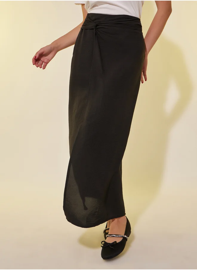 ستايلي Solid Asymmetric Hem Maxi Skirt with Twist Detail