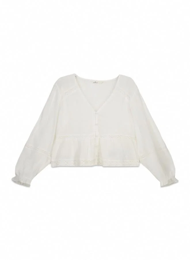 Springfield  White long sleeve blouse. V-neck. Front buttons. Waist with ruffle. Lace detail on the yoke, sleeves, waist and hem. Cuffs with elasticated trim and ruffles. This garment is made from sustainable cotton. for Women | Best Price UAE