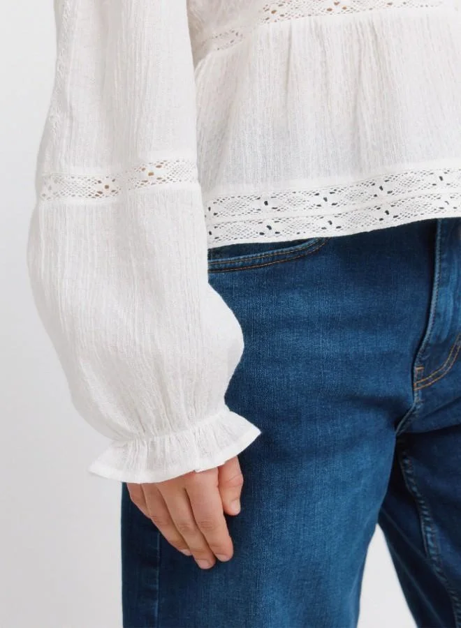 Springfield  White long sleeve blouse. V-neck. Front buttons. Waist with ruffle. Lace detail on the yoke, sleeves, waist and hem. Cuffs with elasticated trim and ruffles. This garment is made from sustainable cotton. for Women | Best Price UAE