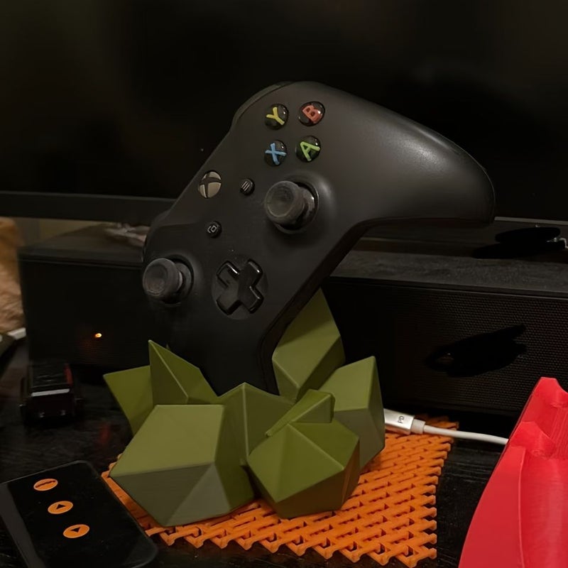 حامل أخضر عسكري لوحدات تحكم Xbox يعرض صخوراً لأجهزة Xbox وPS - Image 1