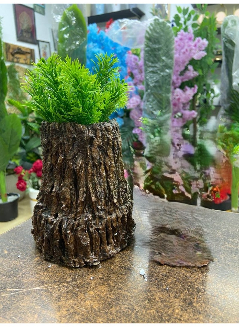 NAMA Small artificial plant in a tree trunk design pot (wood).