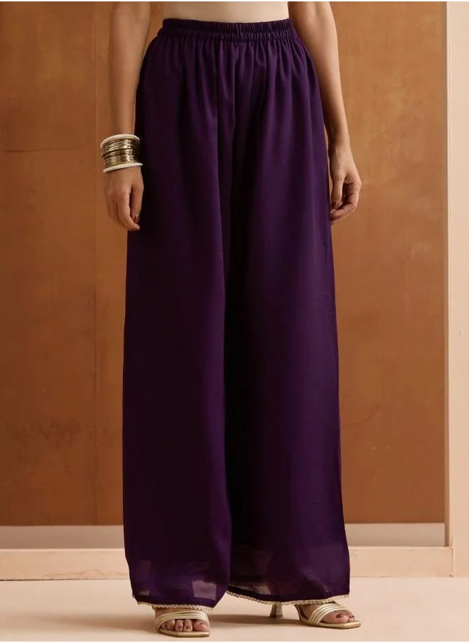 ISHIN Palazzo Women Purple Rayon Kurta Set with Embroidered pattern Tunic and Palazzo features a Round neckline and Three-Fourth Sleeve secured with Elastic closure and styled in Straight Fit ideal for Festive moments — a must-have for your statement wardrobe.