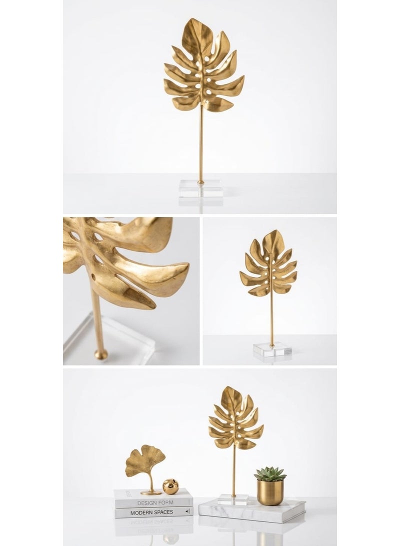 A stunning gold metal decorative piece in the shape of a tropical monstera leaf with a transparent acrylic base - a modern and elegant decoration for tables and bookshelves - Image 1