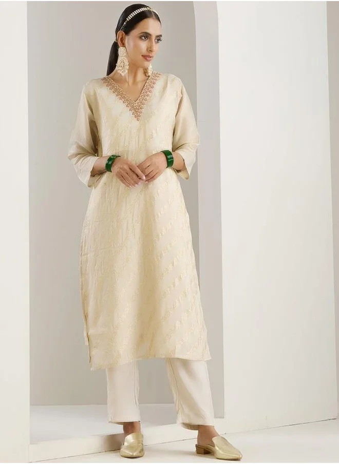 ISHIN Palazzo Women White Poly silk Kurta Set with Embroidered pattern Tunic and Palazzo features a Round neckline and Three-Fourth Sleeve secured with Elastic closure and styled in Straight Fit ideal for Festive moments — a must-have for your statement wardrobe.