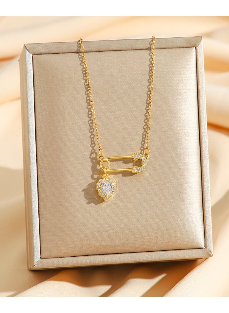 World Luxury Elegant gold necklace with a safety pin and studded heart design - a touch of soft luxury - Image 2