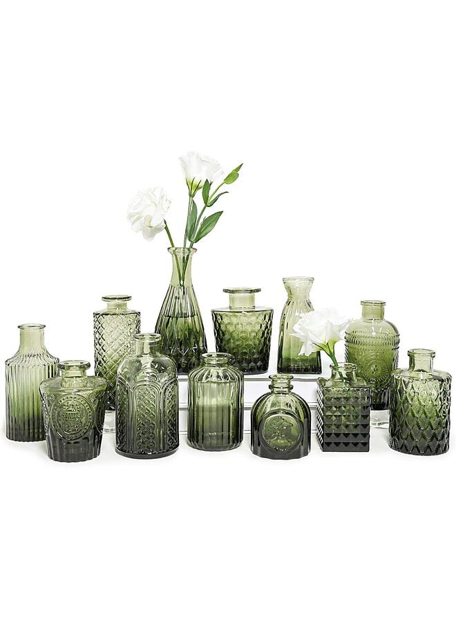 يُسلِّم مجموعة من 12 مزهرية زجاجية صغيرة داكنة اللون، مثالية لتزيين الطاولات. - Image 1