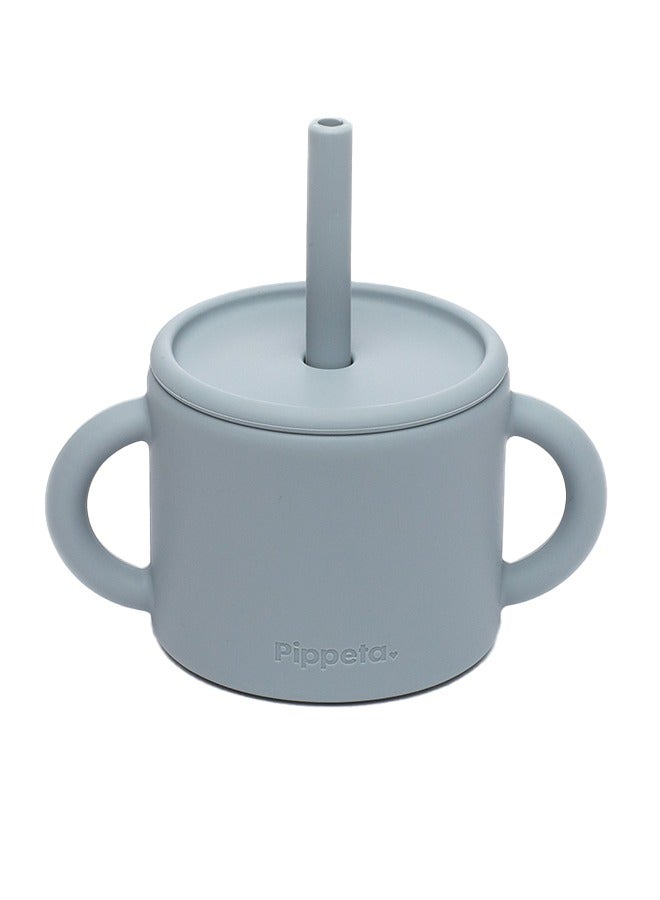 Pippeta The Pippeta Silicone Baby Cup with Straw is designed to support your baby’s transition from bottle to independent drinking. Featuring a 2-in-1 design, it can be used as both an open cup and a straw cup, helping babies develop essential drinking skills. Made from BPA-free, food-grade silicone, it is soft, safe, and gentle for everyday use. The double handles are perfectly sized for little hands, encouraging confidence and self-feeding. Durable, unbreakable, and easy to clean, it is both microwave and dishwasher safe. A practical and thoughtfully designed essential for growing babies learning to drink on their own. - Image 1