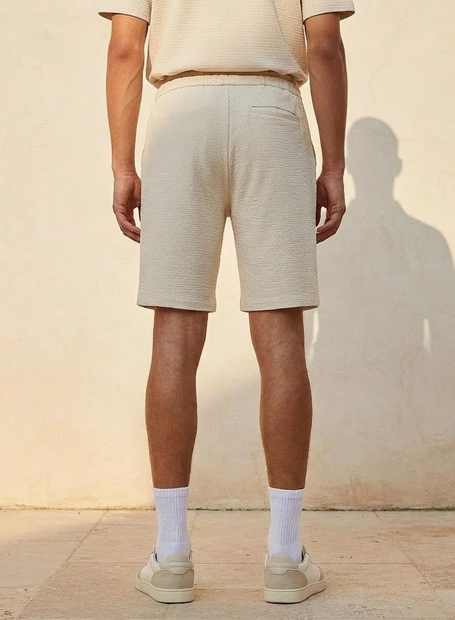 Iconic BEIGE Iconic Regular Fit Shorts for Men | Best Price UAE