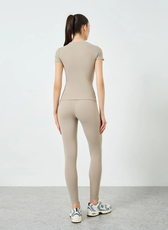Styli Active  Beige Short Sleeve Fitted Top and Leggings Set for Women | Best Price UAE