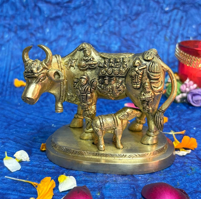 Kartique Brass Kamadhenu the Wish-Fulfilling Cow with Bhagwan Engraving Idol Surabhi Statue for Home Decor Vastu Feng Shui Good Luck Marriage Couple Gift Gold Color Height 3.5 Inch - Image 1