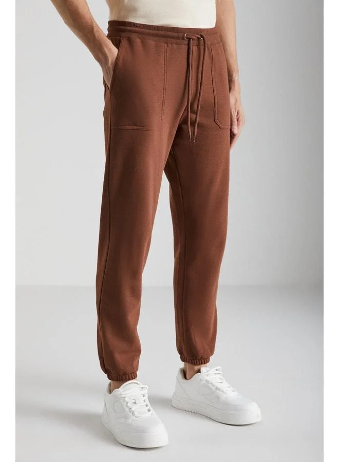 GRIMELANGE Goran Men's Organic Cotton Sweatpants with Polar Lining, Top Pockets, Elasticated Cuffs, Brown.