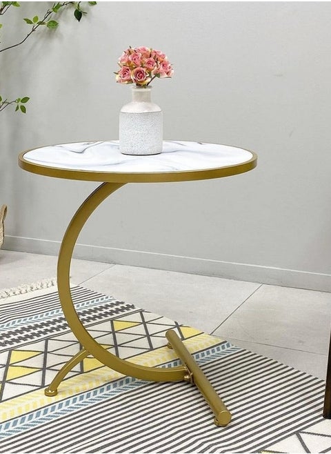 Small C-shaped double-layer side table next to the sofa and bed