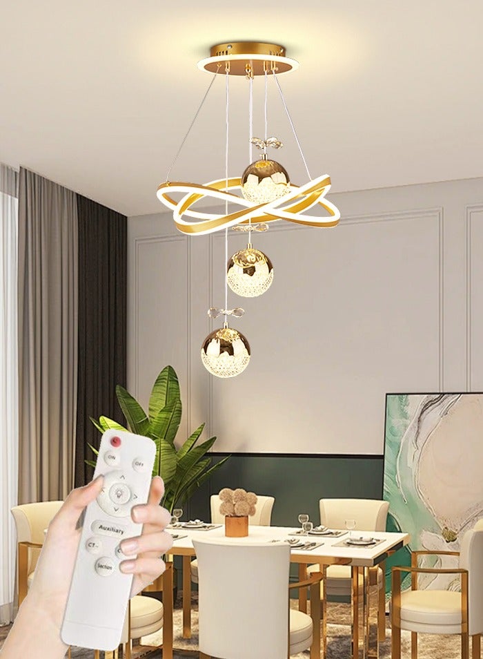 A fashionable LED chandelier with three spherical lamp heads and crystal embellishments, featuring three different light colors, adjustable height, suitable for bedrooms, living rooms, dining rooms and family rooms. - Image 1