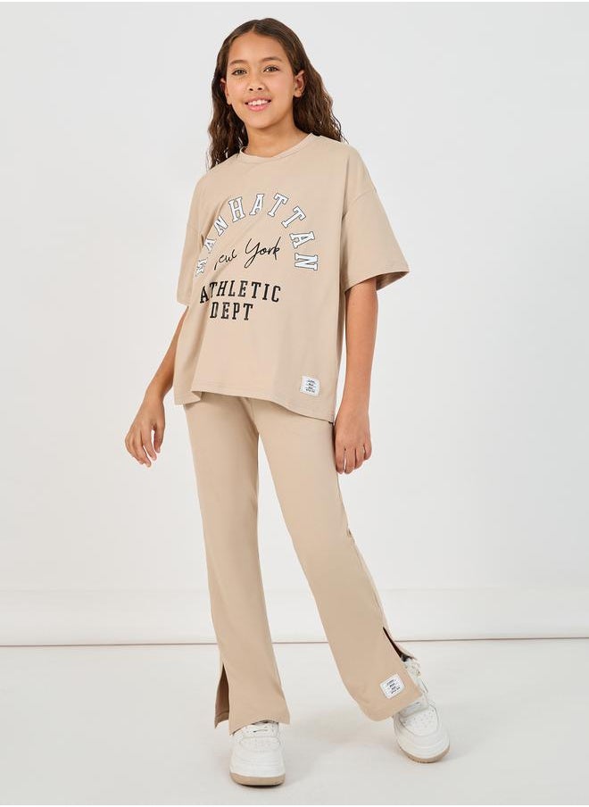 Styli Graphic Print Round Neck T-Shirt & High Rise Pants Co-Ords  - Image 1