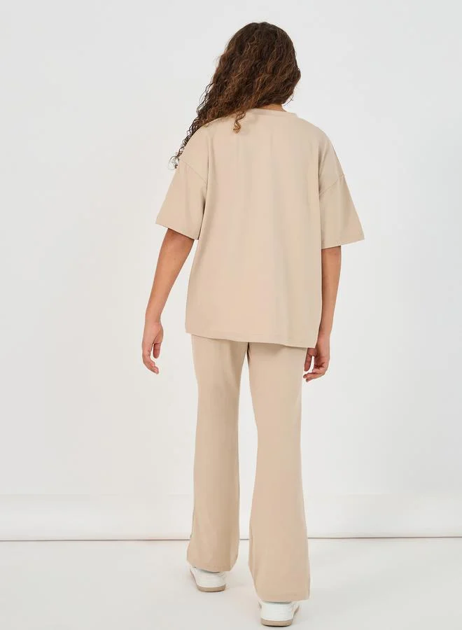 Styli Graphic Print Round Neck T-Shirt & High Rise Pants Co-Ords