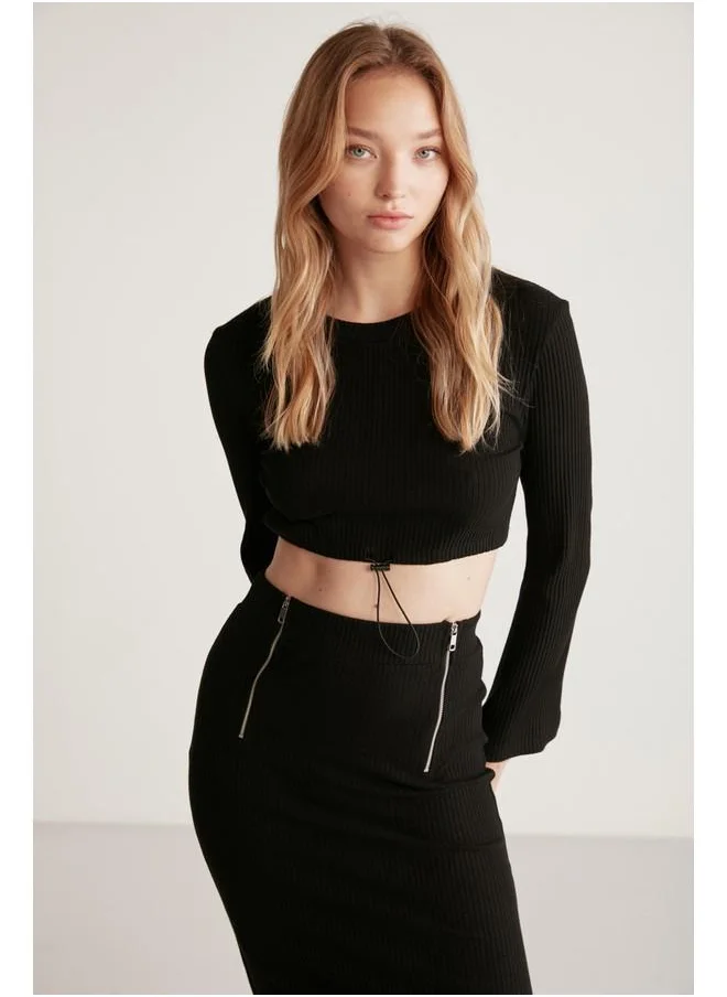 GRIMELANGE Grimelange Darlene Women's Ribbed Stretch Fabric Flare Sleeve Elastic Hem Stopper Crop Black Blouse