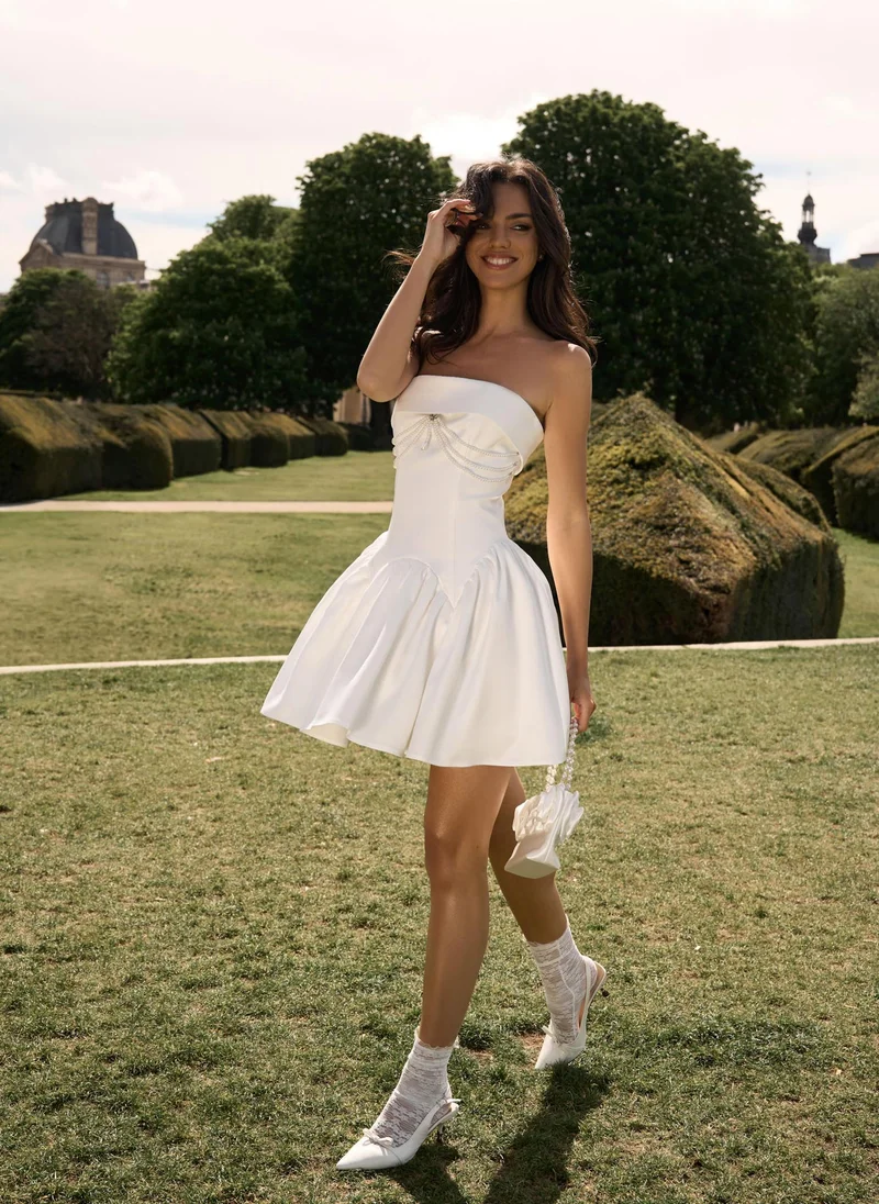 Lichi Mini dress with open shoulders and pearl detail on the bodice