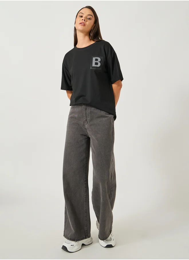 ستايلي Solid Round Neck T-Shirt with Badge Detail