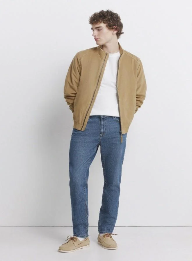 Springfield Medium-dark stretch slim fit 5-pocket jeans, made from soft-touch denim. Design with faux selvedge detail on coin pocket. Medium-dark wash with a worn look. Zip fly fastening.