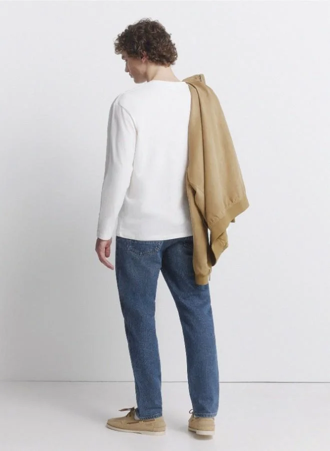 Springfield  Medium-dark stretch slim fit 5-pocket jeans, made from soft-touch denim. Design with faux selvedge detail on coin pocket. Medium-dark wash with a worn look. Zip fly fastening. for Men | Best Price UAE