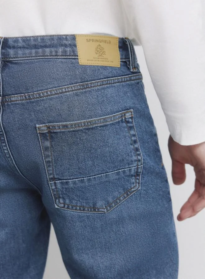 Springfield  Medium-dark stretch slim fit 5-pocket jeans, made from soft-touch denim. Design with faux selvedge detail on coin pocket. Medium-dark wash with a worn look. Zip fly fastening. for Men | Best Price UAE