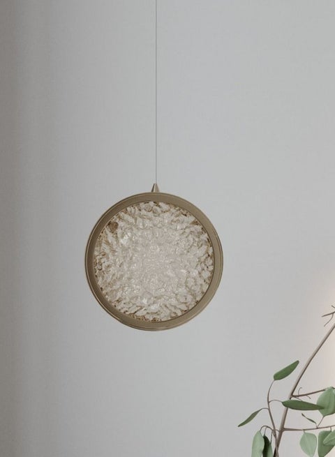 A simple circular chandelier hanging with a luxurious gold frame from Yocandel