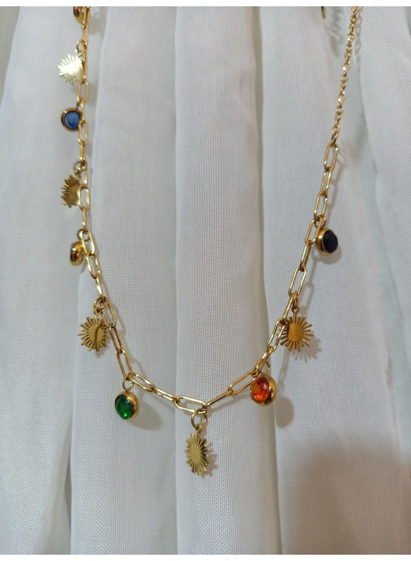 Luxuria This striking gold chain necklace features a modern design combining sun-shaped pendants and colorful gemstones. The chain itself is made of thick links, giving it a distinctive look. - Image 2