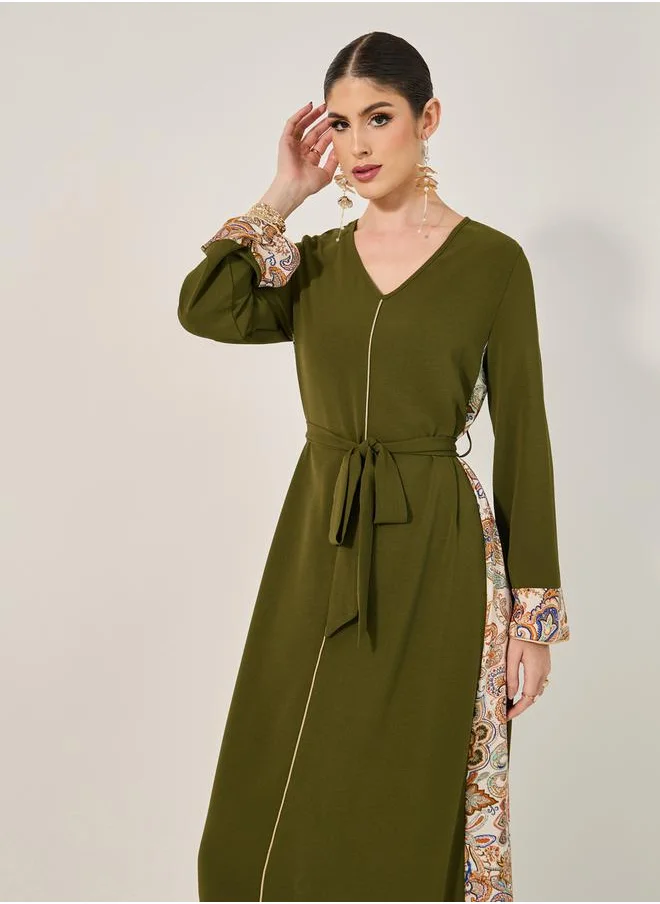 ستايلي navy olive colour jalabiya w/ navy blue pailsey print inserts at sides and slv cuff w/ gold cord trim at CF and sleeve hem