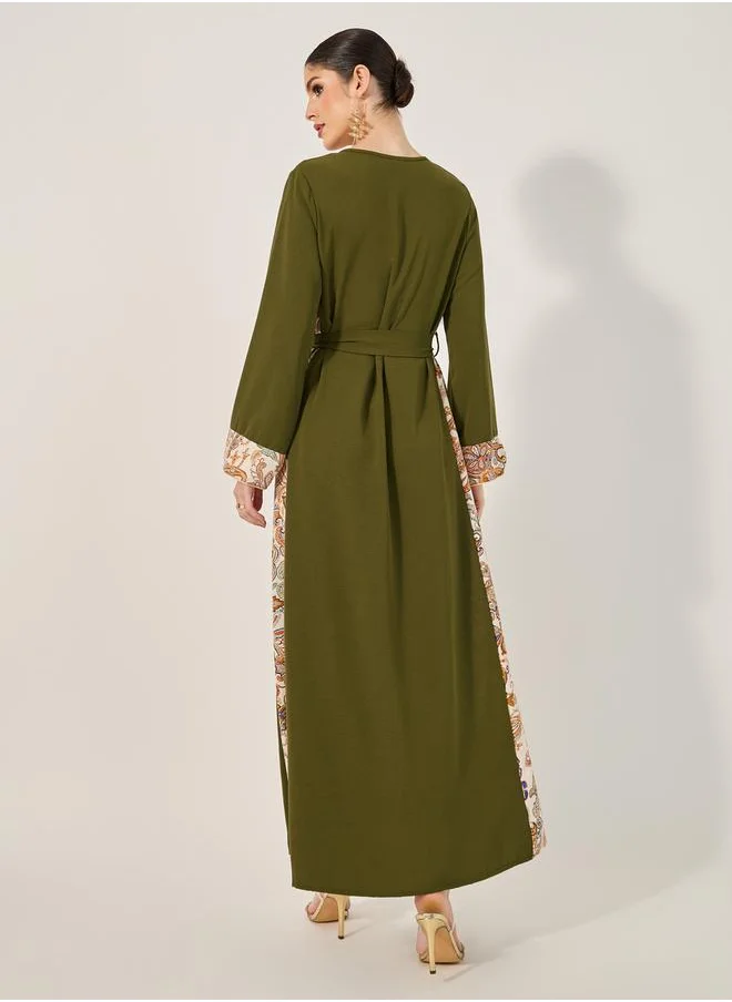 ستايلي navy olive colour jalabiya w/ navy blue pailsey print inserts at sides and slv cuff w/ gold cord trim at CF and sleeve hem