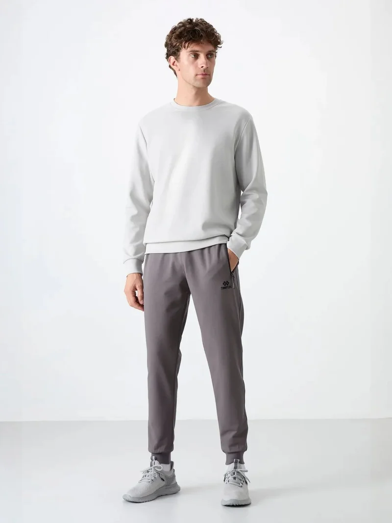 تومي لايف TOMMY Men's Solid Pull-on Sweatpants With Zip Pocket