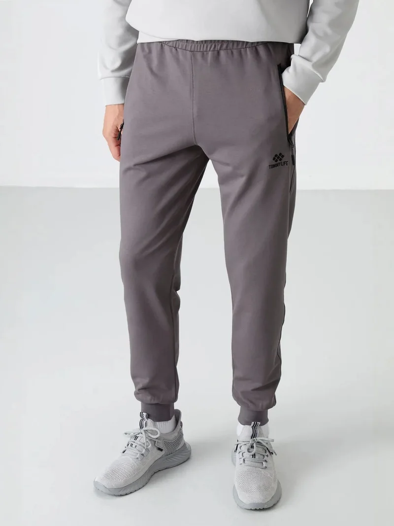 تومي لايف TOMMY Men's Solid Pull-on Sweatpants With Zip Pocket