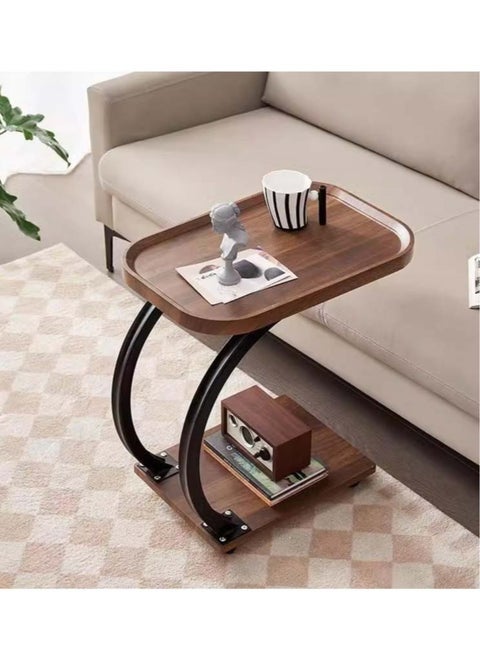 Small C-shaped double-layer side table next to the sofa and bed