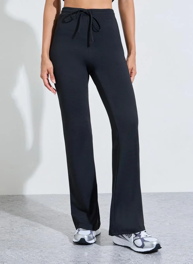 Styli Active  Black Solid Fitted T-Shirt And Flared Pants Active Set for Women | Best Price UAE